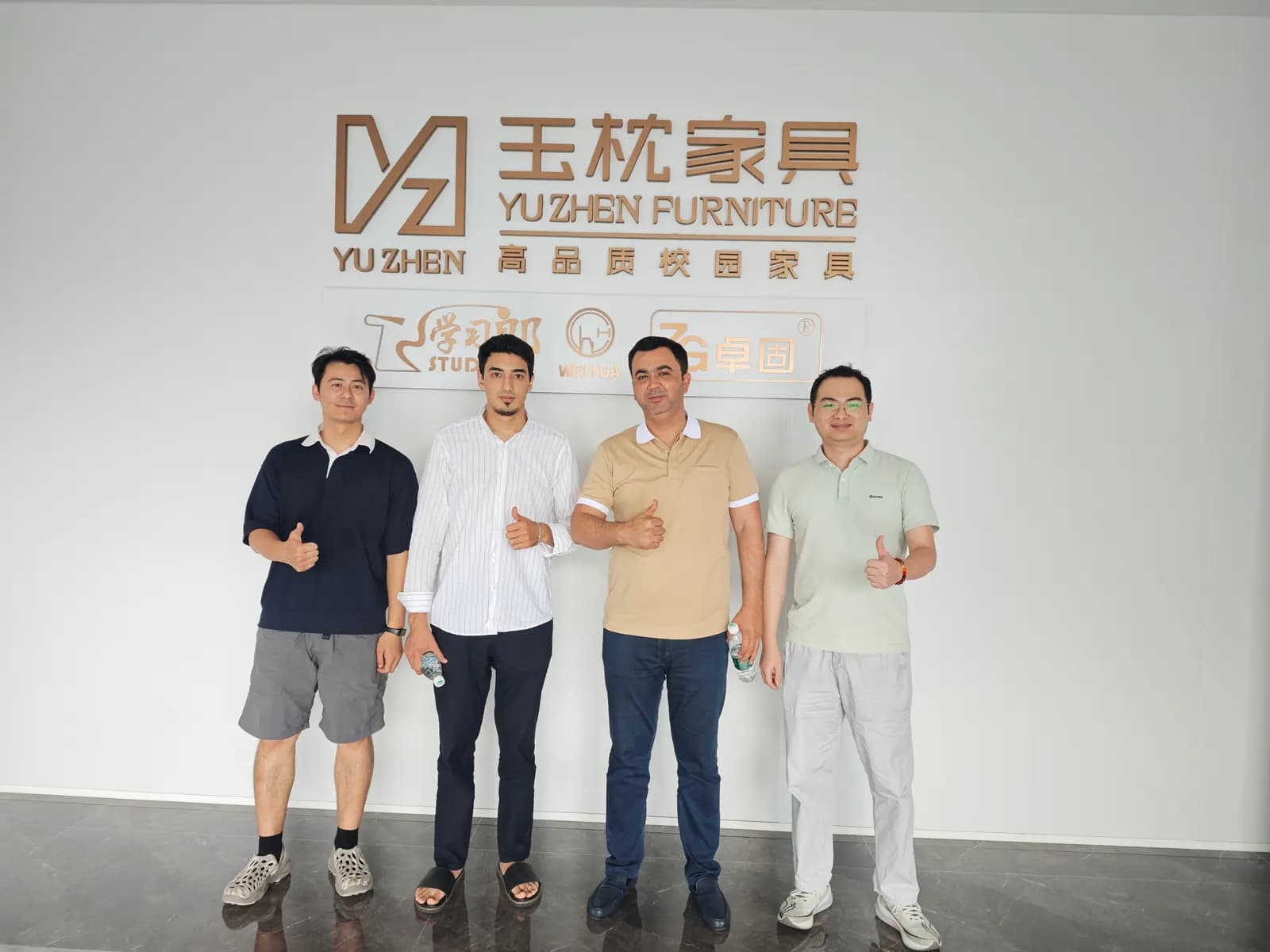Yuzhen team reviewing furniture requirements during a customer visit Yuzhen team reviewing furniture requirements during a customer visit