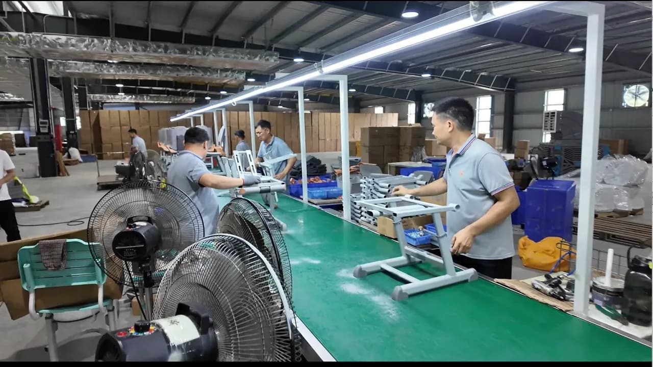 Yuzhen Team Furniture Assembly Line Process Multiple workers assembling campus furniture frames along a green production line at Yuzhen's factory